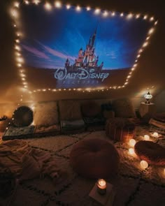 a bedroom with lights on the ceiling and a disney poster above it