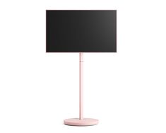 a flat screen tv sitting on top of a pink stand