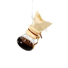 an ornament hanging from a string with a bottle in it