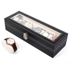 a watch in a black box next to it's cufflinks and ring