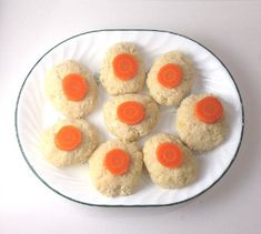 a white plate topped with cookies covered in carrots