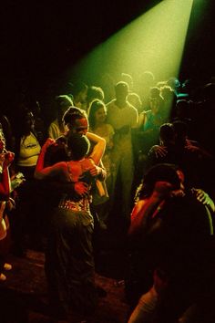 two people hugging each other in front of a crowd