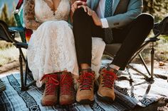 a man and woman sitting next to each other on a blanket