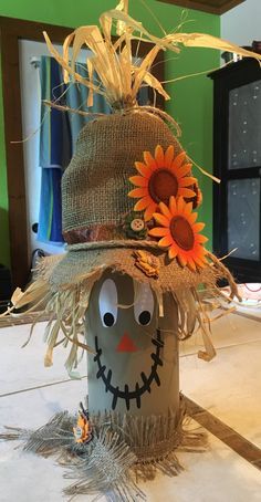 a scarecrow hat with sunflowers on it