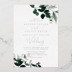 a wedding card with greenery on it