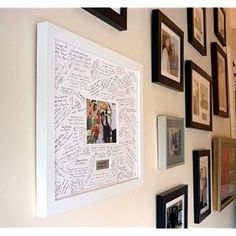 a wall with many pictures and family photos on it, all framed in black and white