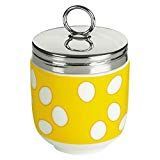 a yellow and white canister with polka dots on the side, holding a metal lid