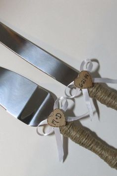 two wedding forks tied up with twine and hearts on the top one is for each other