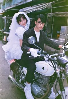 a bride and groom are sitting on a motorcycle