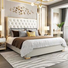 a bedroom with a large bed and gold accents on the headboard, along with two nightstands