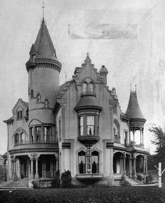 an old black and white photo of a large house with turrets on it's roof