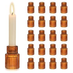 a tall candle is surrounded by many small candles