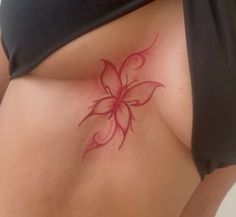 a woman's stomach with a flower tattoo on it