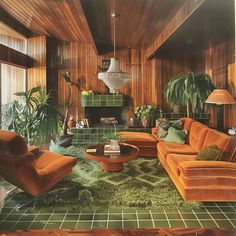 a living room filled with orange couches and green carpeted flooring next to a fire place