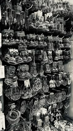 there are many necklaces on display at the market stall in this black and white photo