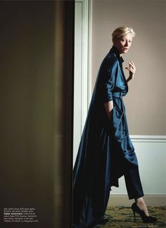 a woman in a blue coat and high heels