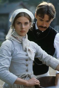 a man and woman dressed in period clothing