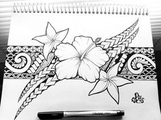 a black and white drawing of a flower on a piece of paper next to a pen