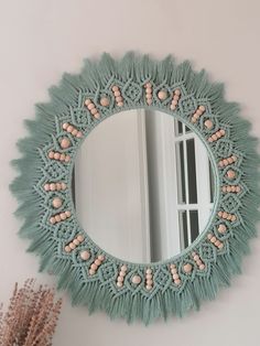 there is a mirror on the wall with beads