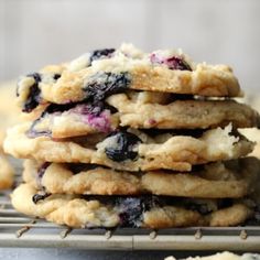 a stack of blueberry cookies sitting on top of a cooling rack