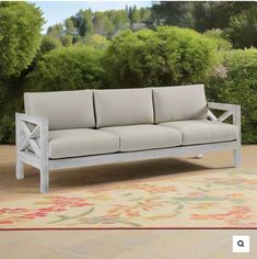 a white couch sitting on top of a patio