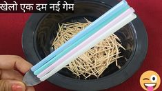 three chopsticks in a black bowl with straw