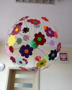 a paper flower umbrella hanging from the ceiling