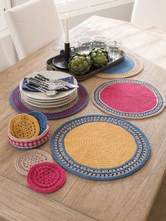 crocheted placemats and plates on a wooden table