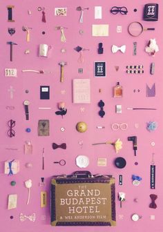 a pink wall covered in lots of different types of items and things that are on top of it