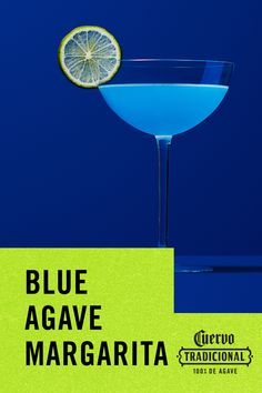 a blue agave margarita with a slice of lemon on the rim in front of it