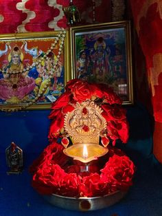 a lit candle is sitting on a blue table with other items in front of it