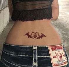 a woman with a bat tattoo on her stomach