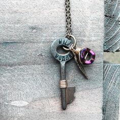 an old key with two charms attached to it