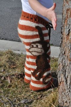 a child's leggings with a monkey on it is next to a tree