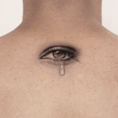 a man's face with an eye drawn on the side of his chest and tear coming out of it