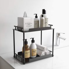 two tiered shelf with soap, lotion and hand sanitizers on it