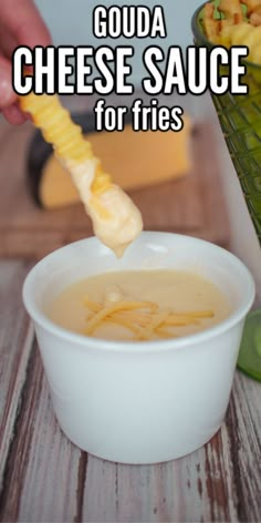 a person dipping cheese sauce into a bowl