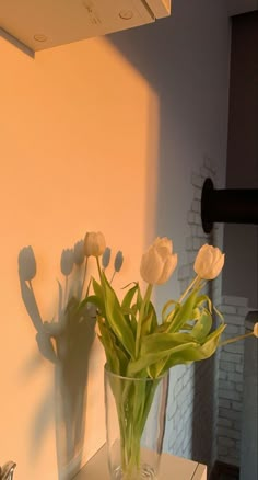 some white flowers are in a clear vase