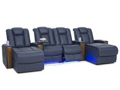 a row of blue leather reclining chairs with lights on the side and back seats facing each other