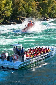 a boat filled with people riding on top of a river