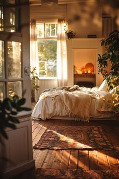 a bedroom with a bed, rugs and plants on the floor in front of an open window