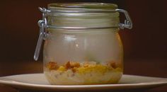 a glass jar filled with food sitting on top of a table