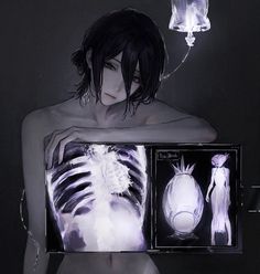 a woman holding an x - ray in front of her chest and the image is lit up