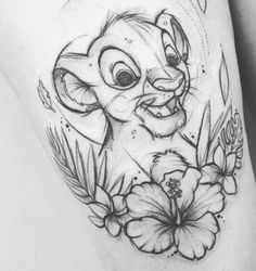 the lion and flower tattoo on the thigh