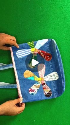 someone is making a bag out of old jeans