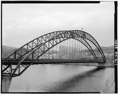 an old black and white photo of a bridge