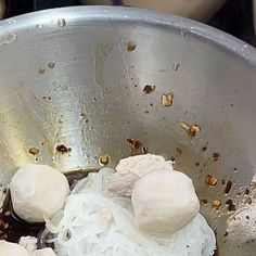 some food is being cooked in a metal bowl