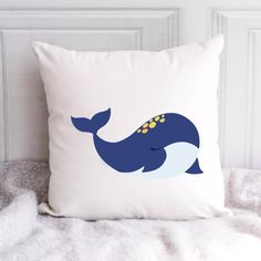 a white pillow with a blue whale on it