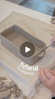 a person is working with clay on a table