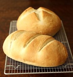 two loaves of bread sitting on a cooling rack